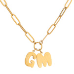 A gold-plated necklace with a chunky bubble letter pendant.
