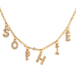 A gold-plated necklace with sparkling stone encrusted letters spelling out the name 'SOPHIE'.