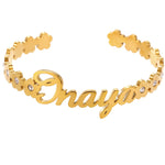 Gold bracelet with 'Onaya' engraving on a white background