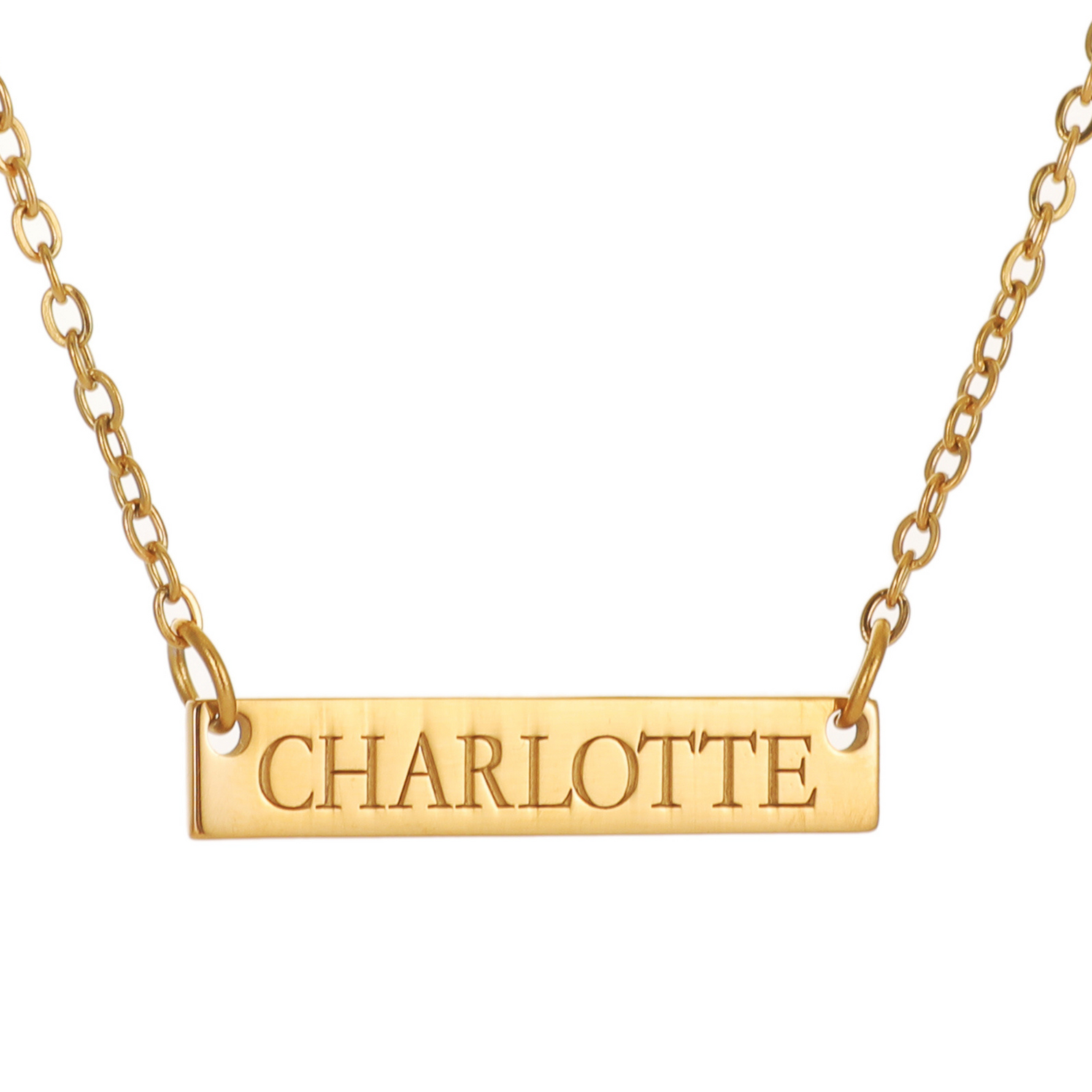 A gold necklace with a bar pendant engraved with the name Charlotte.